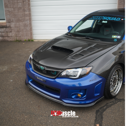 JDMuscle front carbon fiber lip for 2011-2014 Subaru WRX/STI, sleek vehicle front lip enhancement with textured carbon fiber finish.