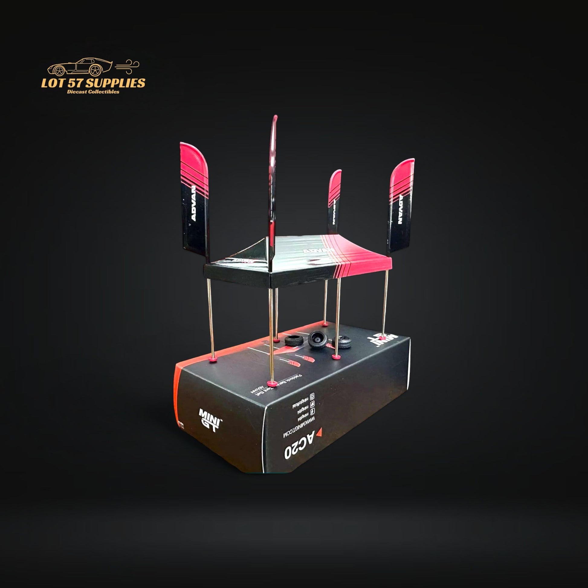Mini-GT Paddock Service Tent accessory by Lot57Supplies for 1:64 scale Advan diecast racing cars, shown on display.