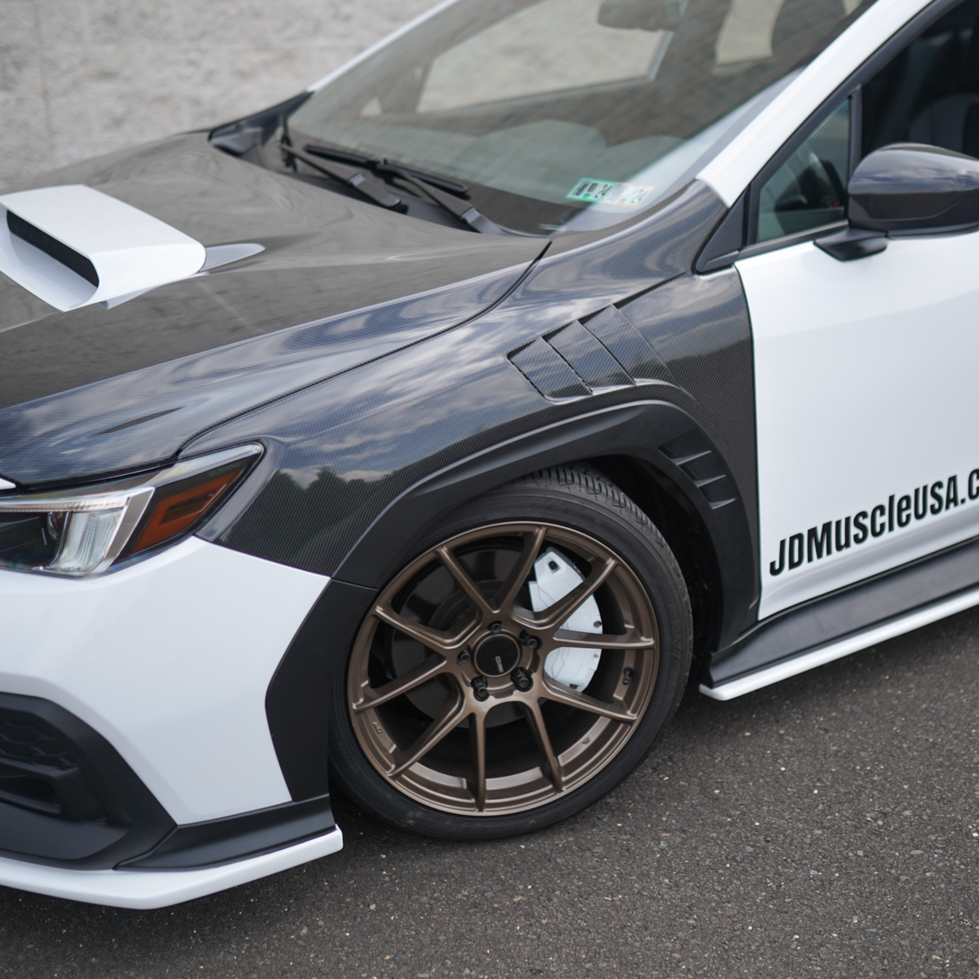 JDMuscle Tanso carbon fiber hood for Subaru WRX 22-25 models, OEM+ style 2-piece design with aerodynamic vents.
