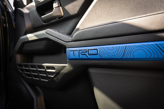 Vinyl interior door line overlays for 2024+ Toyota Tacoma by StickerFab, showing sleek black trim on vehicle doors.