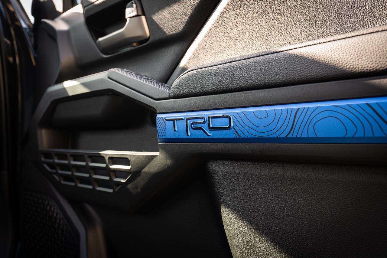 Vinyl interior door overlay with topographic map design for 2024+ Toyota Tacoma, by StickerFab.