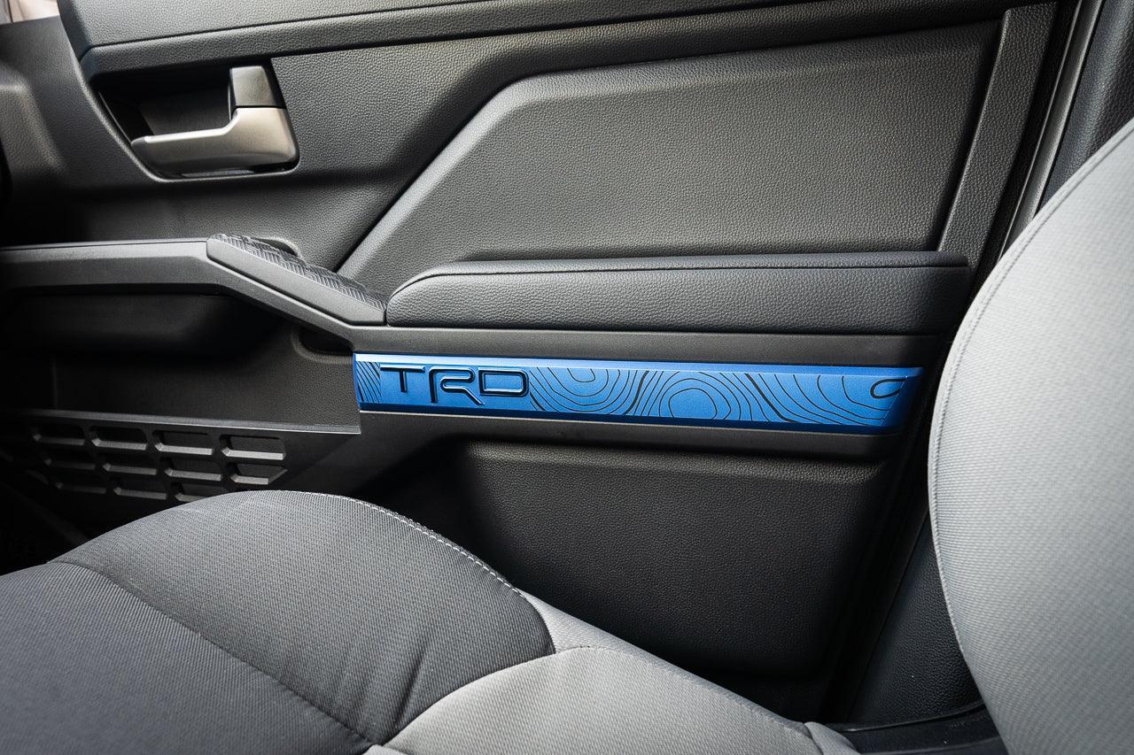 Vinyl interior door line overlays for 2024+ Toyota Tacoma, TRD style, installed on vehicle doors showing sleek black finish.