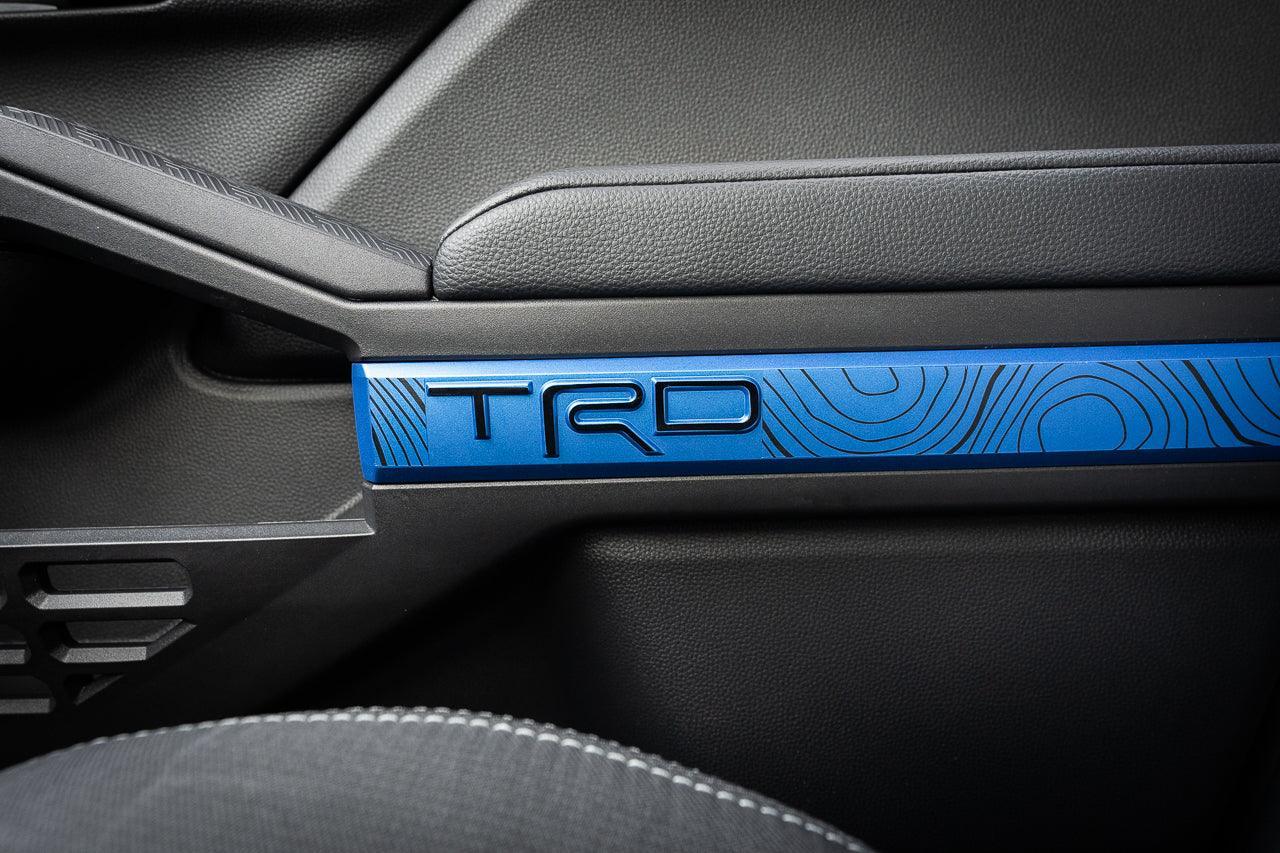 Vinyl door line overlays for 2024+ Toyota Tacoma interior by StickerFab, shown on car door trim in close-up view.