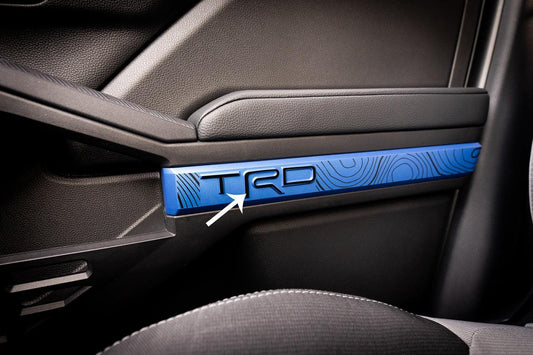 Vinyl TRD door line overlays for 2024+ Toyota Tacoma interior, shown on vehicle door panels with a sleek finish.