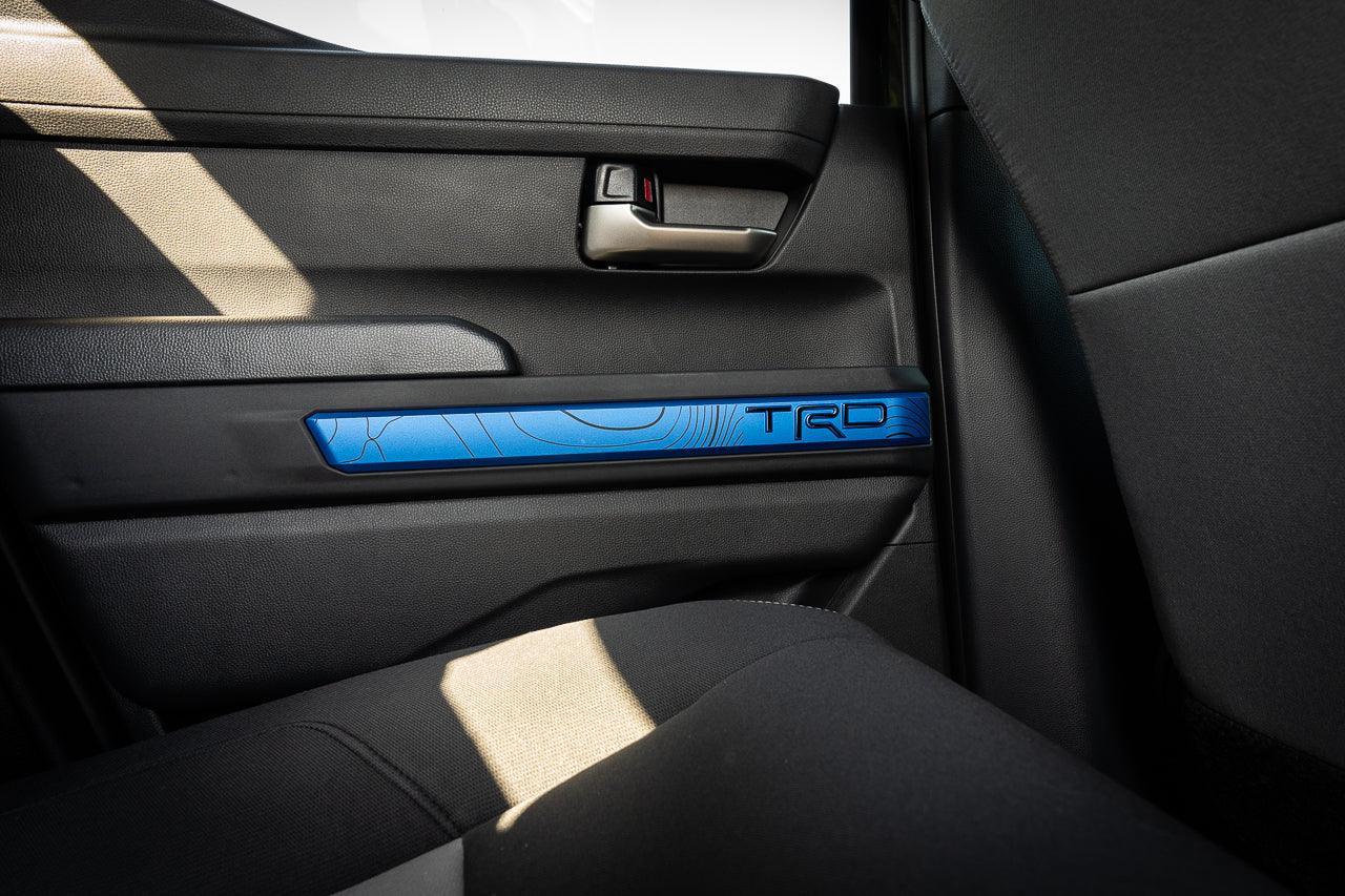 Vinyl door line overlays for 2024+ Toyota Tacoma interior, installed on vehicle doors, by StickerFab.