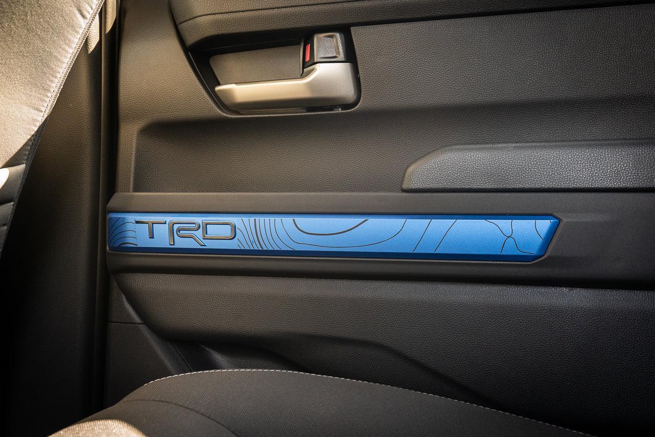 Vinyl door line overlays for 2024+ Toyota Tacoma interior, stylish TRD design by StickerFab on vehicle door panels.