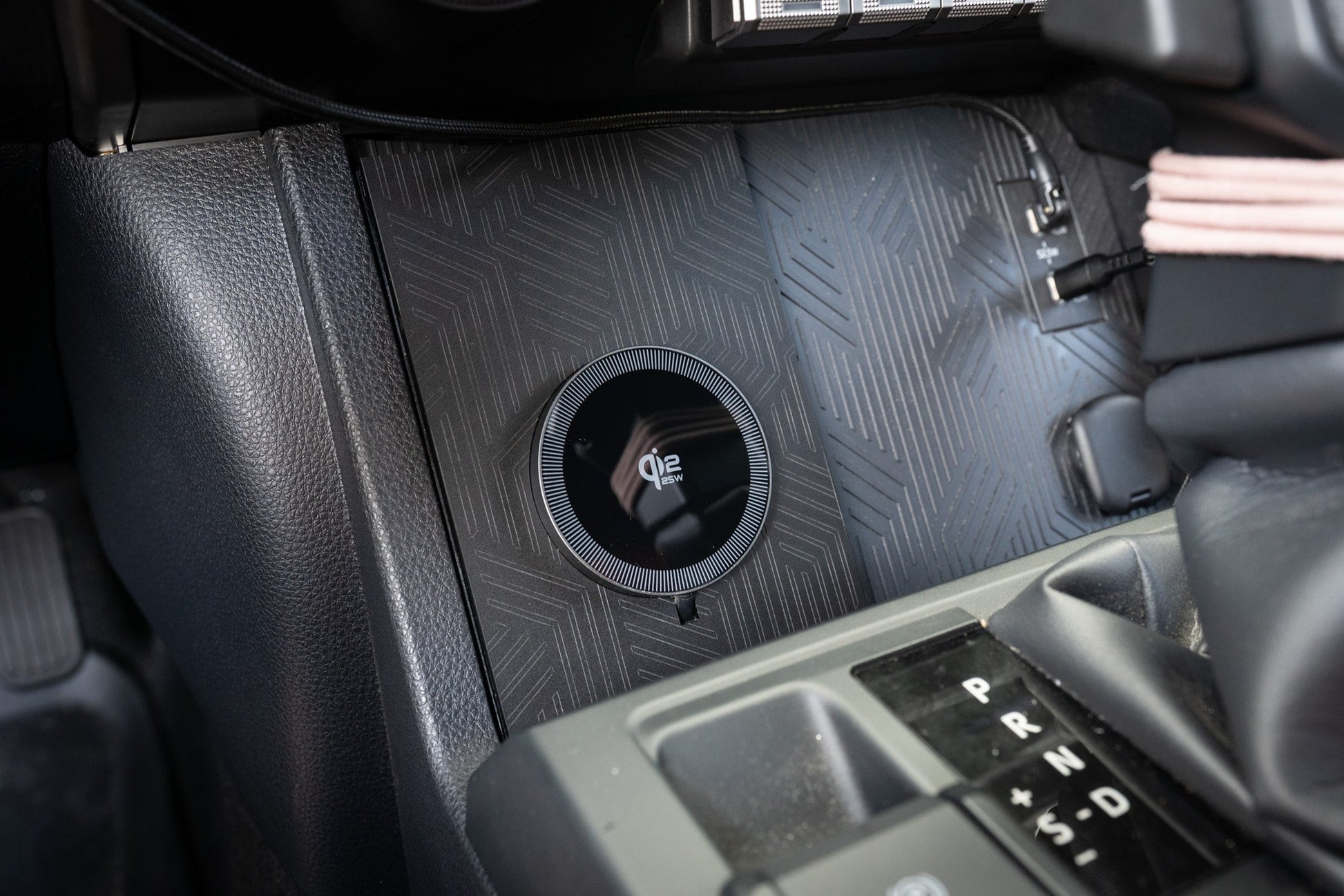 StickerFab 25W MagSafe wireless charger pad mounted in factory cubby for 2024+ Tacoma and 2025+ 4Runner vehicle interior.
