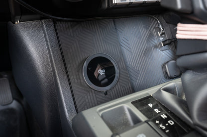 StickerFab 25W MagSafe wireless charger pad mounted in factory cubby for 2024+ Tacoma and 2025+ 4Runner vehicle interior.