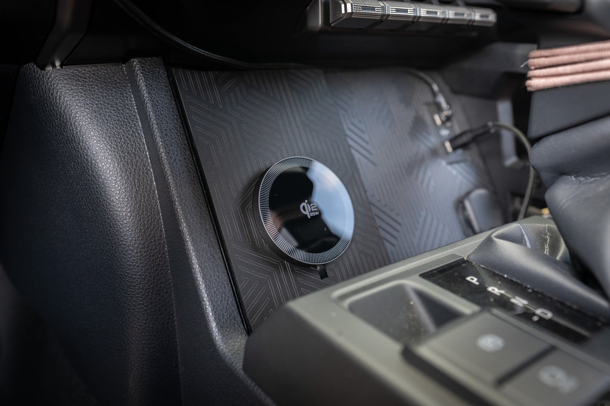 StickerFab 25W Magsafe wireless charger pad mounted in factory cubby for Toyota Tacoma 2024+ or 4Runner 2025+ vehicle.
