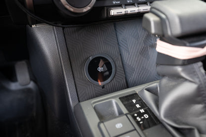 StickerFab 25W MagSafe wireless charger pad mounted in factory cubby for 2024+ Tacoma and 2025+ 4Runner vehicles.