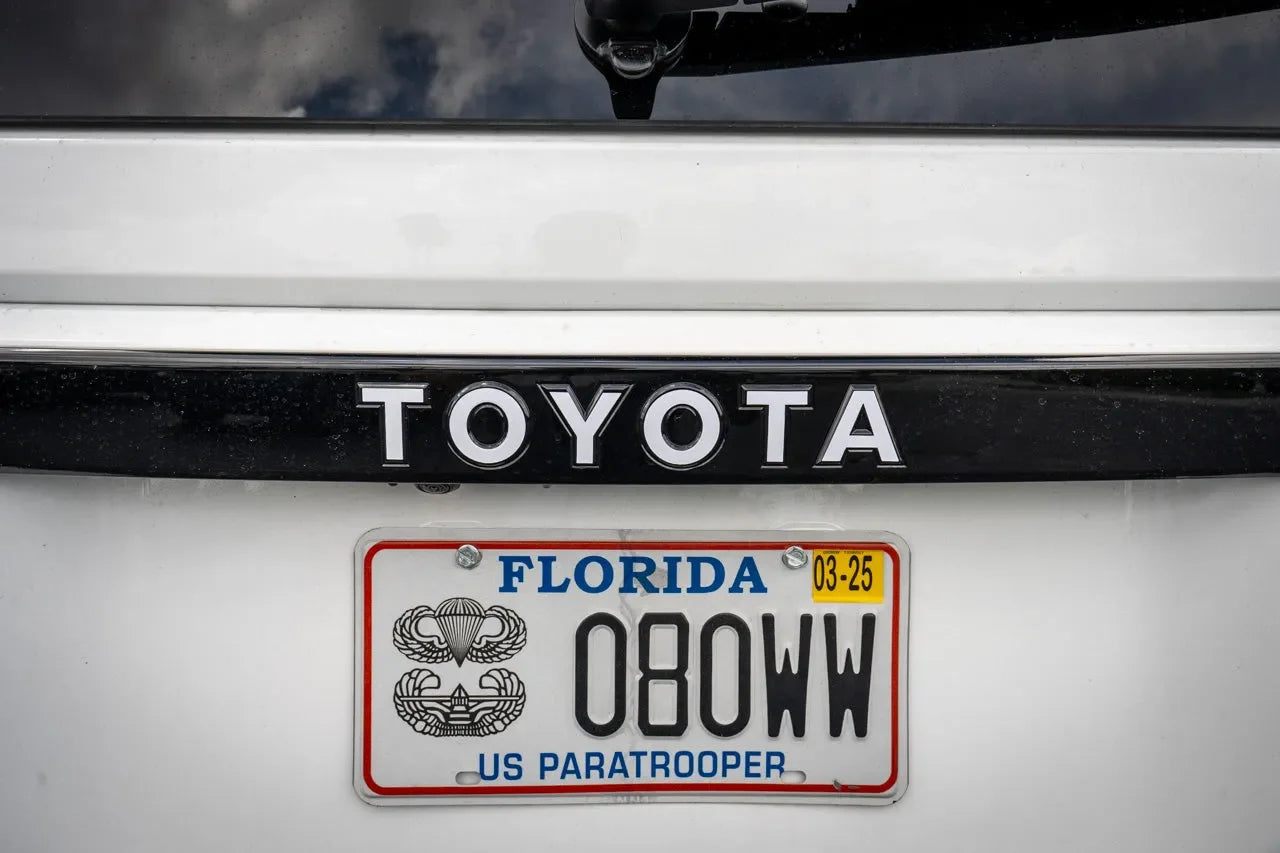 Toyota Land Cruiser 2024+ rear tailgate emblem overlays by StickerFab, close-up view of stylish chrome emblems installed on vehicle.