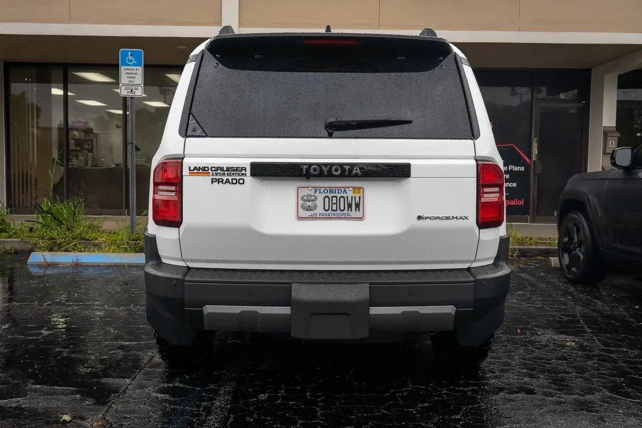 Toyota Land Cruiser 2024+ rear tailgate emblem overlay by StickerFab, showcasing stylish chrome design on vehicle tailgate.