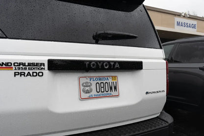 Toyota Land Cruiser 2024+ Topo Rear Tailgate Emblem Overlay by StickerFab, showing a sleek metallic emblem on the tailgate.