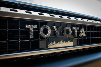 Toyota Land Cruiser and FJ Cruiser emblem kit by StickerFab, front grille emblems for 2007-2014 FJ Cruiser and 2024+ Land Cruiser models.