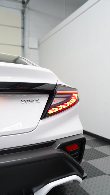 JDMuscle 22-25 WRX Doragon LED tail lights installed on a vehicle, showcasing the bright, sleek red and clear lens design.