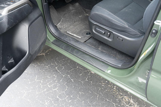 Toyota Tacoma 2016-2023 double cab door sill protectors by StickerFab, showing sleek black aluminum door sill guards.