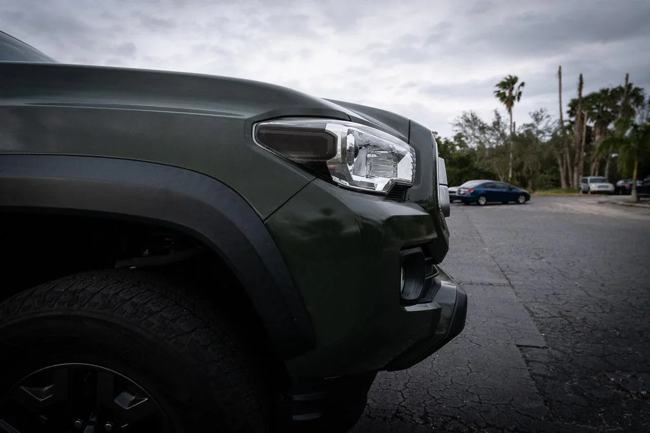 Front smoked sidemarker overlays for 2016-2023 Toyota Tacoma, vinyl exterior accessory by StickerFab, shown on vehicle.