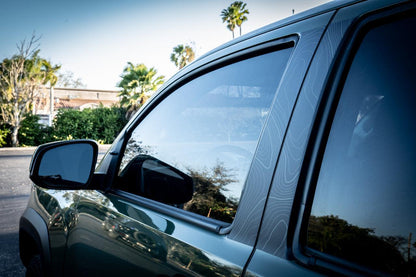 Vinyl Topo B Pillar Overlays for 2016-2023 Tacoma Double Cab, exterior accessory by StickerFab, shown on vehicle door pillars.