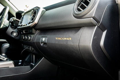 Vinyl glove box inlay with Tacoma logo for 2016-2023 Toyota Tacoma interior, standard series by StickerFab.