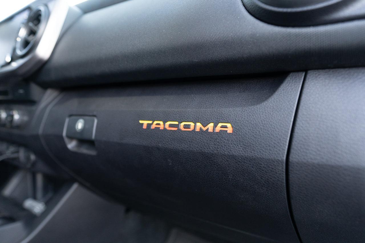 Tacoma glove box with StickerFab printed vinyl logo inlays, designed for 2016-2023 Tacoma interior customization.