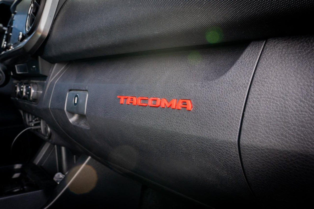 Tacoma glove box interior with StickerFab laser series acrylic logo inlays, vinyl material for 2016-2023 Tacoma truck.