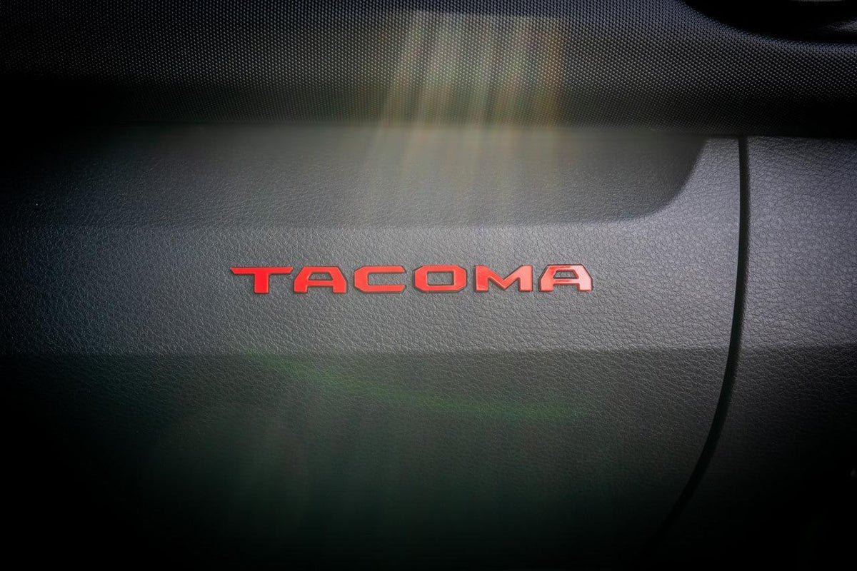 Tacoma Glove Box acrylic logo inlays from StickerFab's Laser Series, designed for 2016-2023 Toyota Tacoma interior vinyl accents.