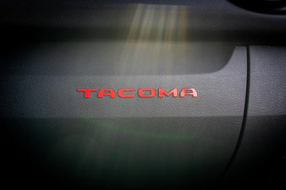 Tacoma Glove Box acrylic logo inlays from StickerFab's Laser Series, designed for 2016-2023 Toyota Tacoma interior vinyl accents.