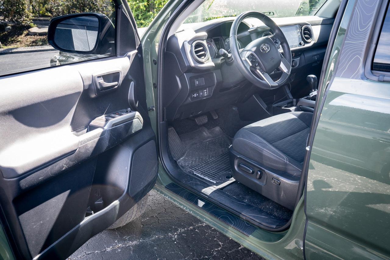 Topo Door Sill Protectors for 2016-2023 Tacoma Double Cab by StickerFab, showing durable metal door sill covers with black finish.