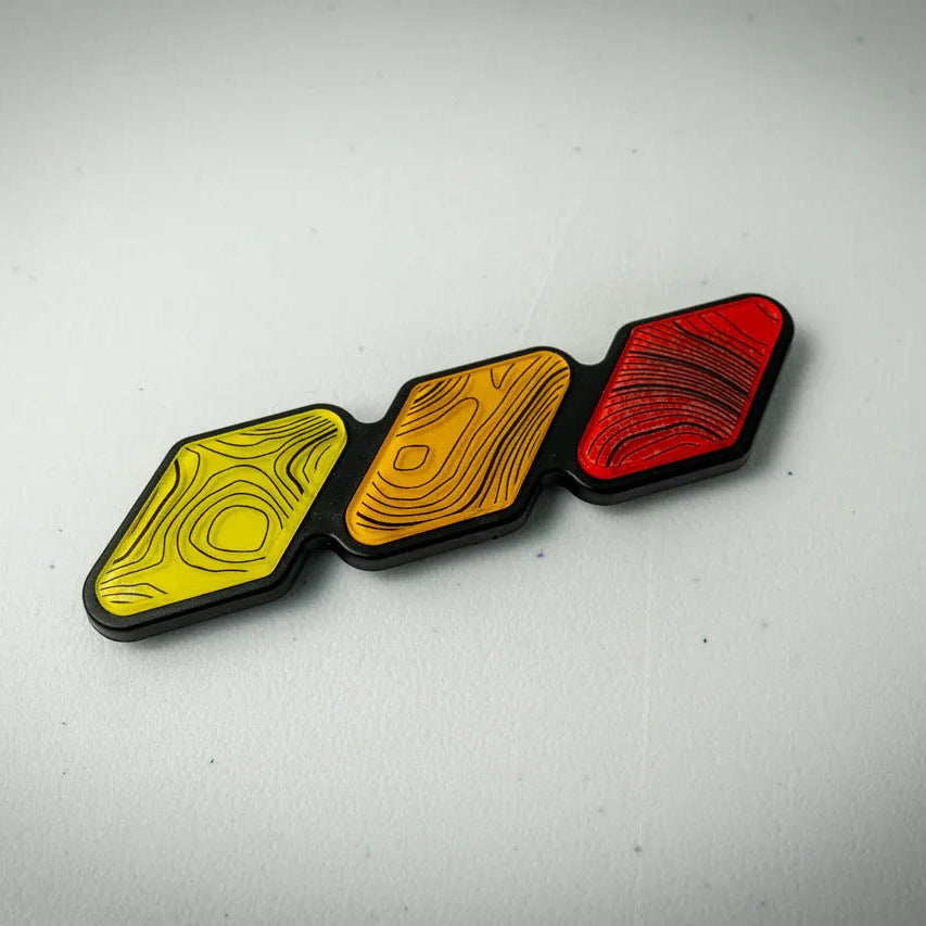 Tri color topographic grille emblem sticker for 2024+ Land Cruiser and 2013-2016 Tacoma, vinyl exterior car decal from StickerFab.
