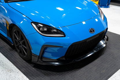 OLM TR Style unpainted front lip for 2022+ Toyota GR86, shown installed on the front bumper