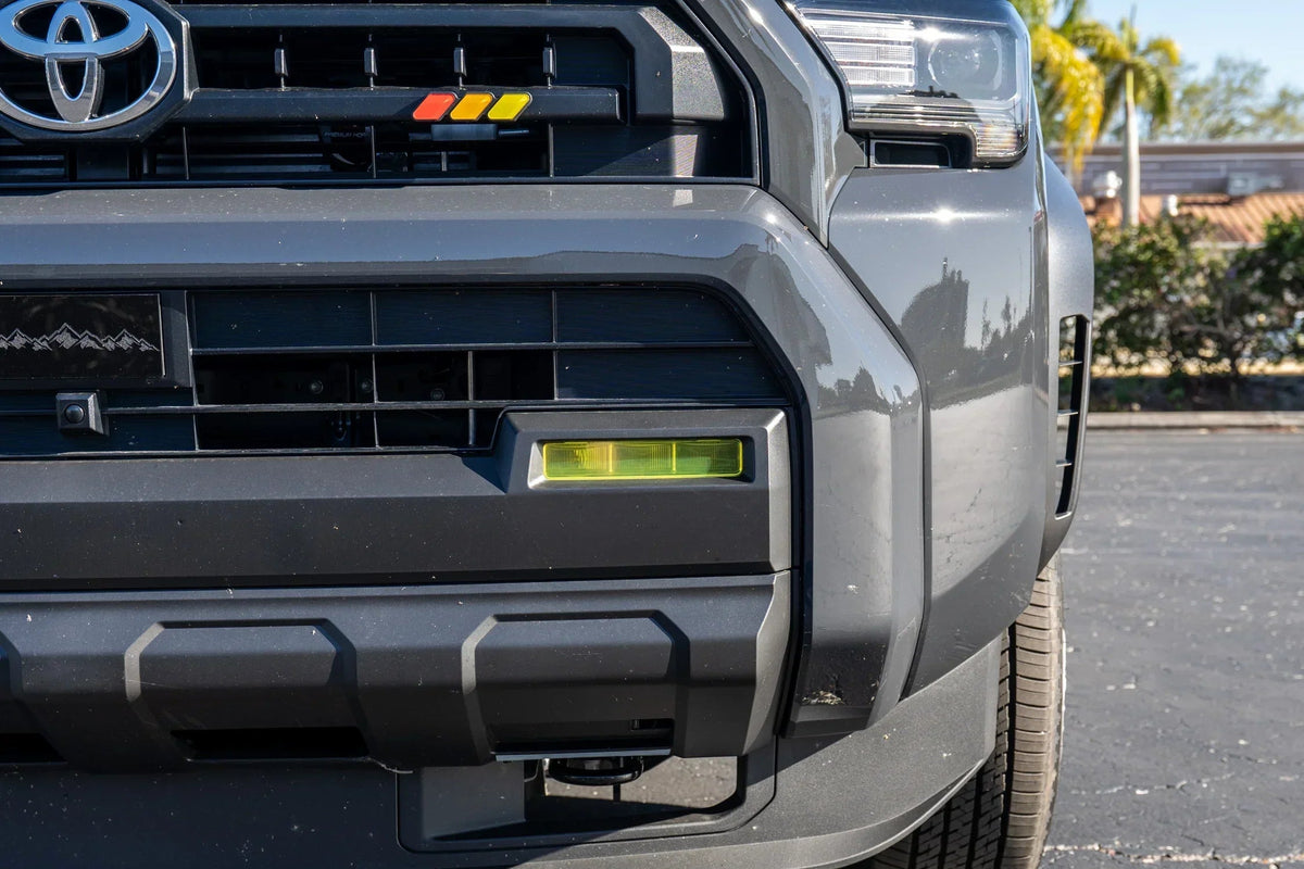 Vinyl fog light overlays for 2024+ Toyota Tacoma, exterior accessory by StickerFab, shown on vehicle fog light area.