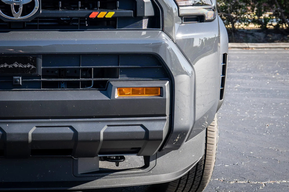 Vinyl fog light overlays for 2024+ Toyota Tacoma, exterior accessory by StickerFab, showing textured black overlay on fog lights.