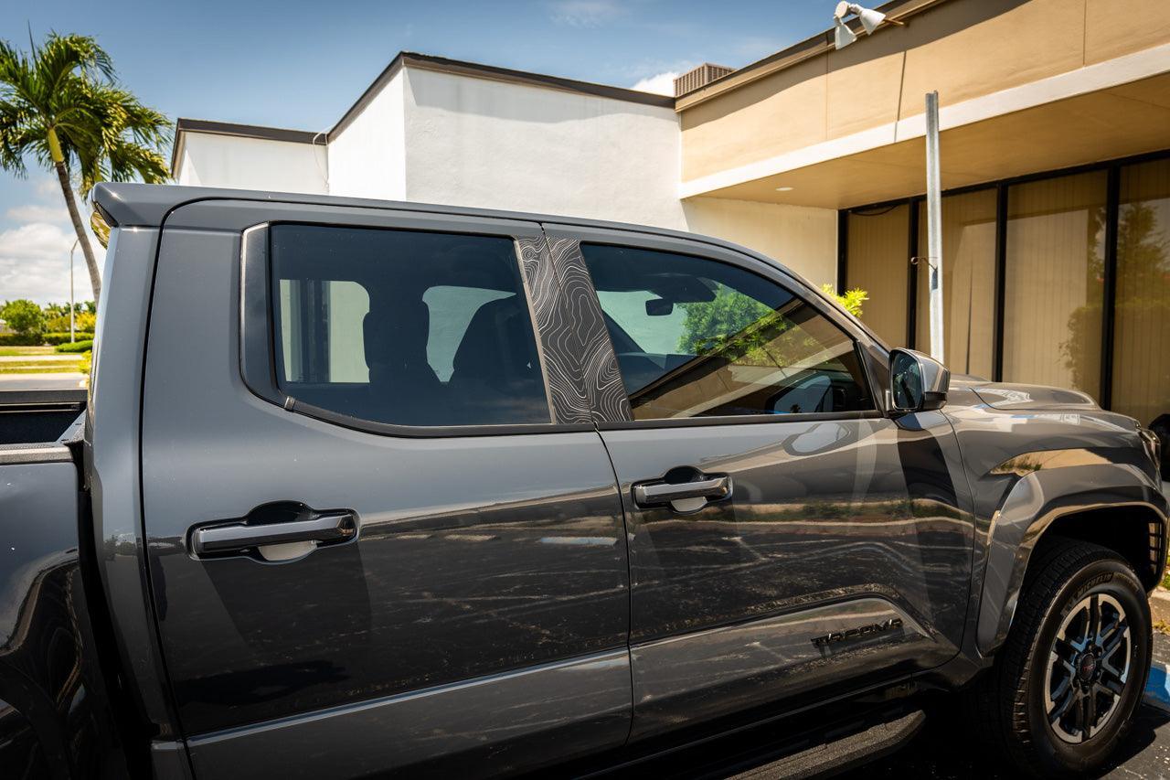 DIY Window Tint Kit for 2024+ Toyota Tacoma Double Cab, exterior vinyl film with partially applied tint on vehicle window.