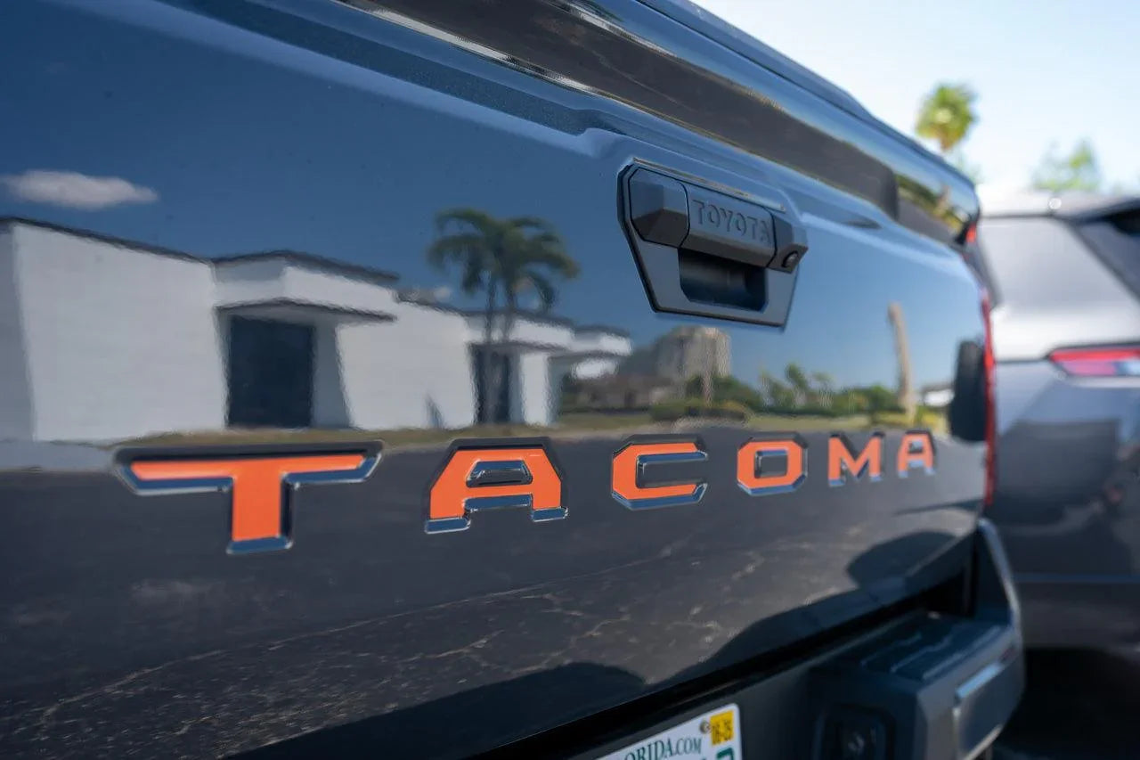 2024+ Toyota Tacoma tailgate handle inlay with standard vinyl letter decals, featuring StickerFab exterior vinyl lettering on the tailgate.