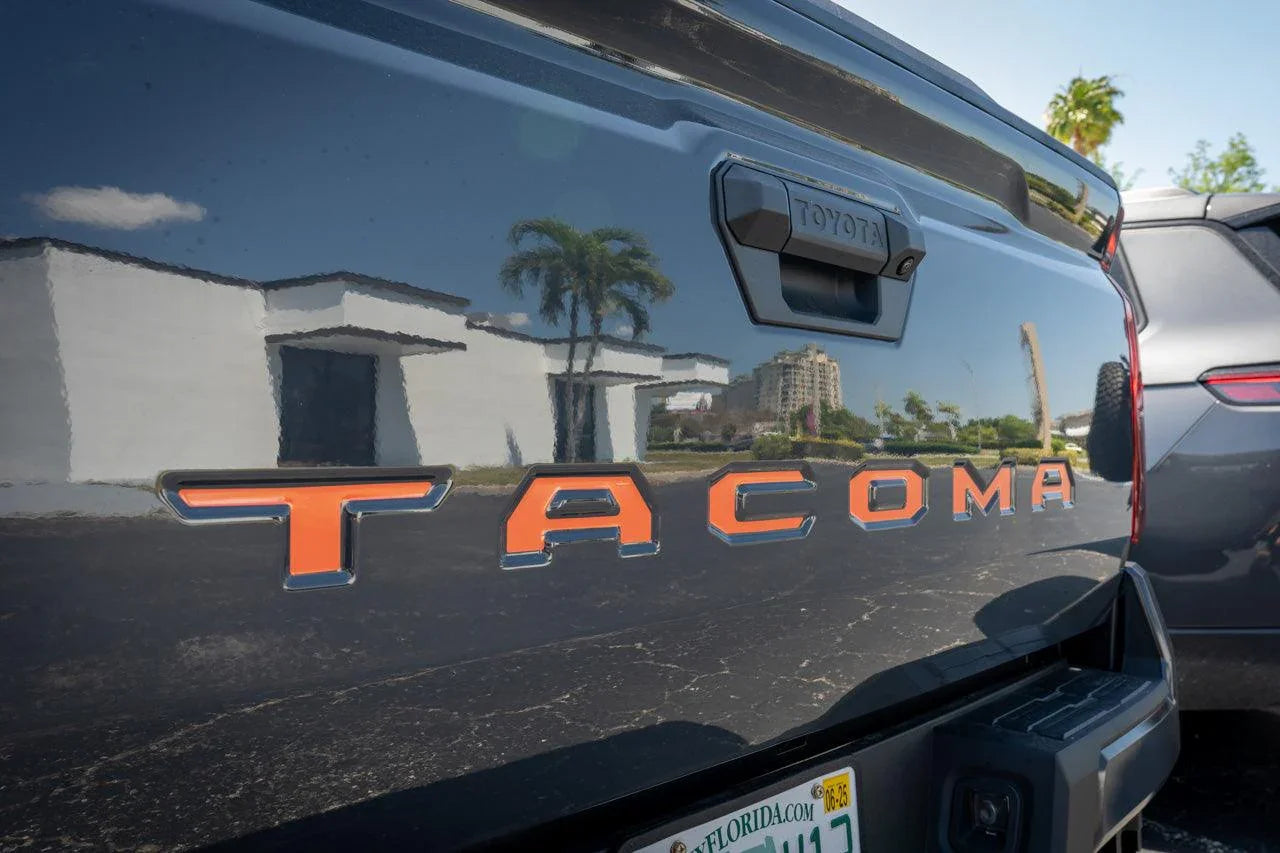 Vinyl exterior tailgate inlay letters for 2024+ Tacoma truck, showcasing custom StickerFab design on a silver tailgate.