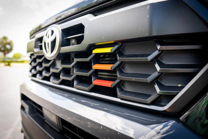 TRD Style Heritage Grille Tri Bar Overlays for 2024+ Toyota Tacoma, vinyl exterior accessory by StickerFab, installed on vehicle grille.