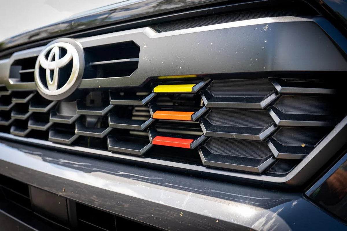 TRD Style Heritage Grille Tri Bar Overlays for 2024+ Toyota Tacoma, vinyl exterior overlays with a sleek tri-bar design.