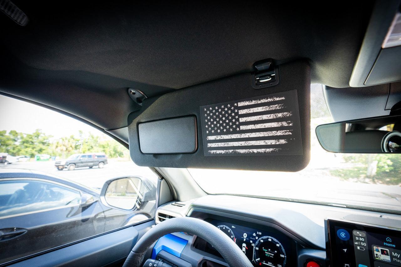 Interior vinyl sun visor airbag label with distressed American flag overlays for 2024+ Toyota Tacoma by StickerFab.