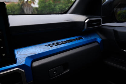 Vinyl interior 3-piece topographic map dash overlays for 2024+ Toyota Tacoma by StickerFab, featuring detailed map designs.