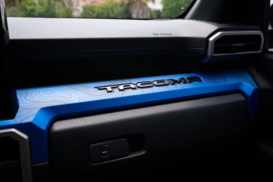 Vinyl interior 3-piece topographic map dash overlays for 2024+ Toyota Tacoma by StickerFab, featuring detailed map designs.