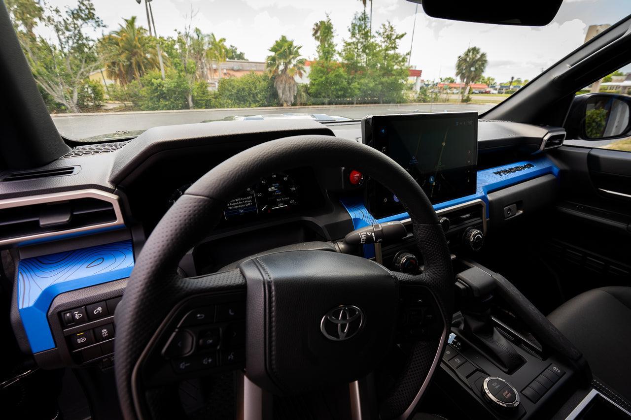 Interior vinyl 3-piece topographic map dash overlays for 2024+ Toyota Tacoma by StickerFab, showing detailed map design.
