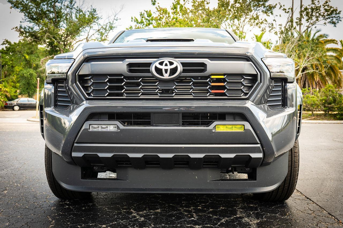 Vinyl fog light overlays for 2024+ Toyota Tacoma, exterior vehicle accessories by StickerFab, shown installed on the fog lights.