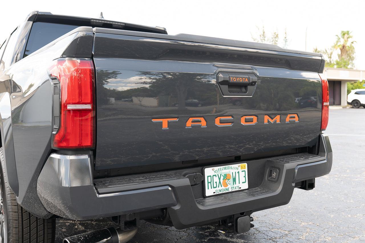 2024+ Tacoma tailgate handle inlay letters with standard vinyl from StickerFab showing black exterior decal on vehicle.