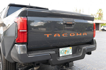 2024+ Tacoma tailgate handle inlay letters with standard vinyl from StickerFab showing black exterior decal on vehicle.