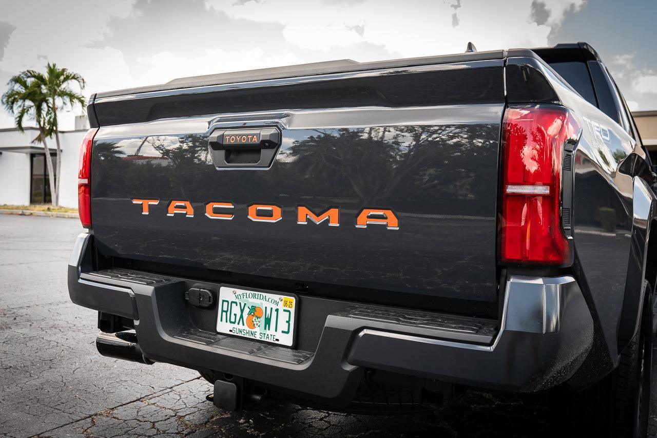 Tailgate handle inlay letters in vinyl for 2024+ Toyota Tacoma, exterior decal by StickerFab featuring standard vinyl design.