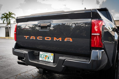 Tailgate handle inlay letters in vinyl for 2024+ Toyota Tacoma, exterior decal by StickerFab featuring standard vinyl design.
