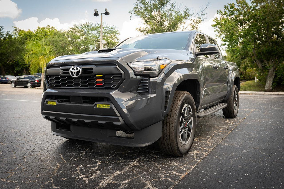 Vinyl fog light overlays for 2024+ Toyota Tacoma, exterior vehicle accessories by StickerFab, shown on a pickup truck.