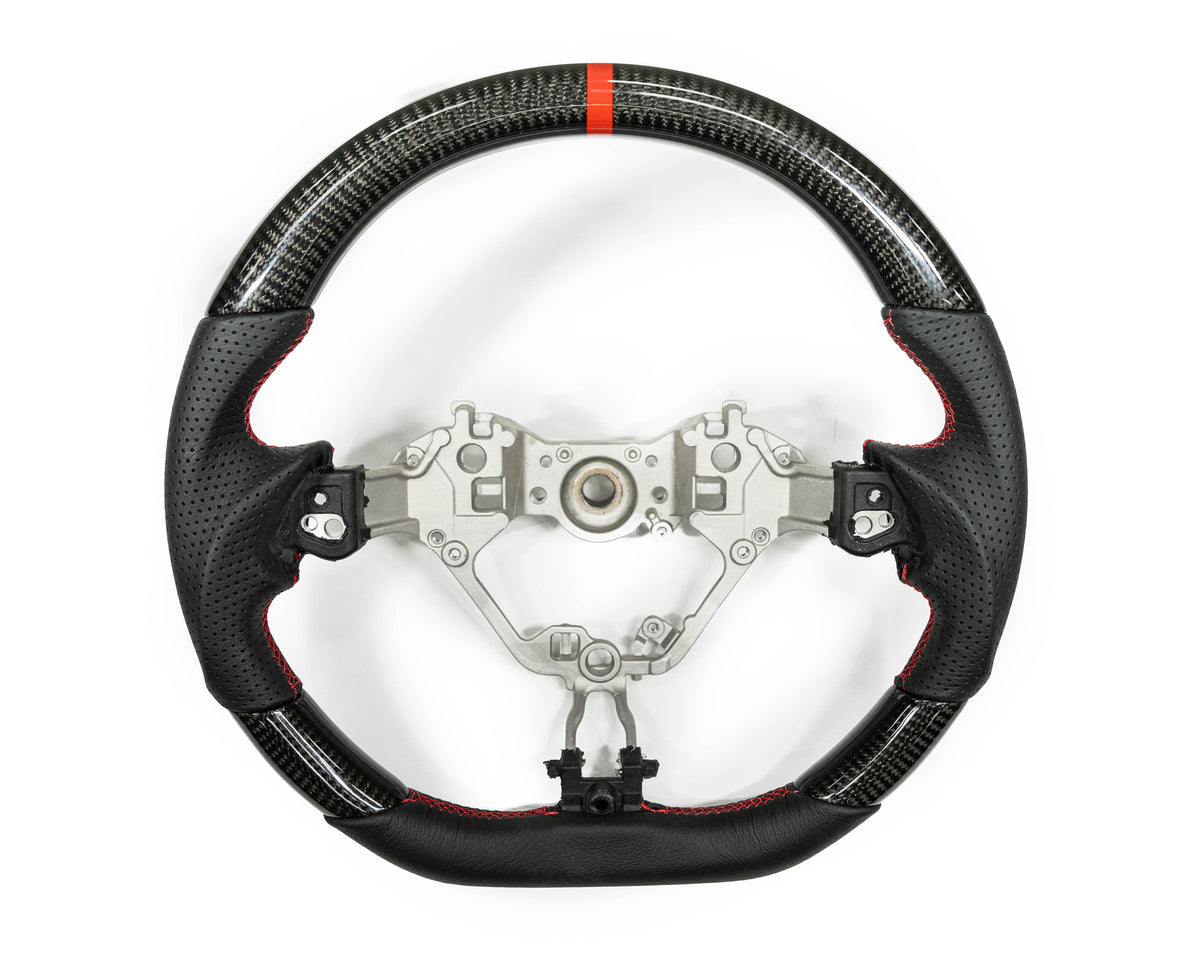 FactionFab carbon and leather steering wheel for 2017+ Subaru BRZ and Toyota 86, featuring a sleek sporty design and high-quality materials.