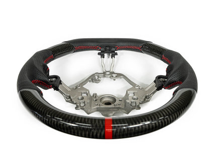 FactionFab steering wheel with carbon fiber and leather, compatible with Subaru BRZ and Toyota 86, shown in close-up view.