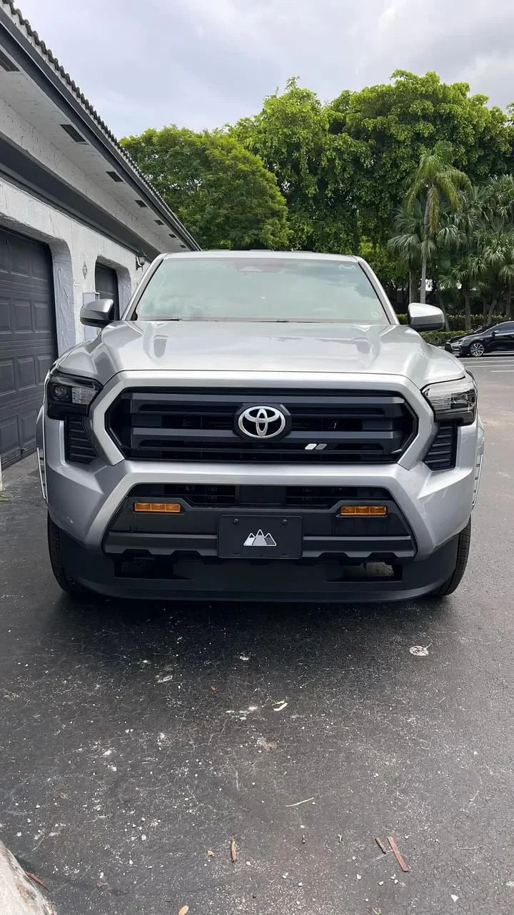 Vinyl fog light overlays for 2024+ Toyota Tacoma, exterior accessory by StickerFab, shown on vehicle with installed overlays.